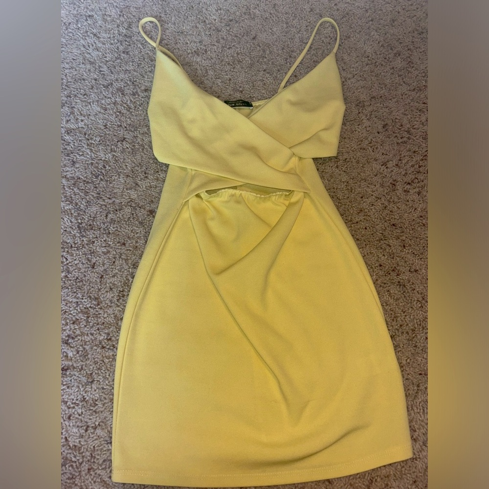 pastel yellow, bodycon mini dress with cutout in middle.